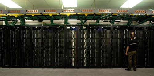 Picture of Data Center showing overhead cable managment with operations personel